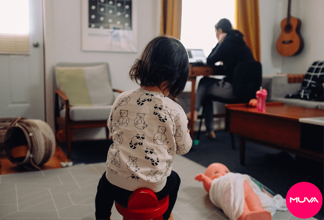 picture of a kid playing while person working