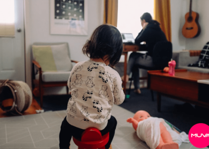 picture of a kid playing while person working